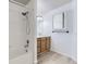 Bright full bathroom featuring a shower-tub combo, white tile, and a medicine cabinet at 12616 Country Meadows Dr, Parker, CO 80134