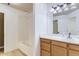 Full bathroom with shower-tub combo, white tile, and wood vanity at 12616 Country Meadows Dr, Parker, CO 80134