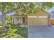 Charming tan two-story home with a red front door, brick accents, and a well-manicured lawn at 12616 Country Meadows Dr, Parker, CO 80134