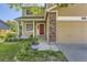 Charming two-story home with a red front door, brick accents, and well-kept landscaping at 12616 Country Meadows Dr, Parker, CO 80134
