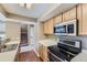 Efficient kitchen with stainless steel appliances, light wood cabinets, and laminate flooring at 12616 Country Meadows Dr, Parker, CO 80134