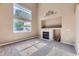 Bright living room featuring a tiled fireplace, large windows, and neutral carpet at 12616 Country Meadows Dr, Parker, CO 80134