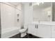 Modern bathroom with white tile walls, a black and white tiled floor, and a sleek vanity at 2876 W 53Rd Ave # 111, Denver, CO 80221