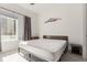 Bright bedroom with a large window, neutral carpet, and a stylish mountain-themed wall decoration at 2876 W 53Rd Ave # 111, Denver, CO 80221