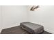 Minimalist bedroom with dark wood floors and a small twin bed at 2876 W 53Rd Ave # 111, Denver, CO 80221