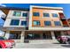 Modern condo building with a combination of wood and concrete finishes, with large windows and a stylish exterior at 2876 W 53Rd Ave # 111, Denver, CO 80221