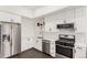 Bright kitchen featuring stainless steel appliances, white cabinets, and a modern subway tile backsplash at 2876 W 53Rd Ave # 111, Denver, CO 80221