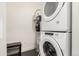 Bright laundry room features a stacked washer/dryer and a modern water heater for convenience at 2876 W 53Rd Ave # 111, Denver, CO 80221