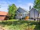 Charming backyard features a well-maintained lawn, a cozy patio set, and a lovely view of the home's exterior at 4453 S Pagosa Way, Aurora, CO 80015