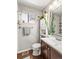 Well-lit bathroom featuring a modern vanity, large mirror, and decorative plants for a refreshing ambiance at 4453 S Pagosa Way, Aurora, CO 80015