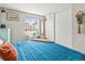 Well-lit bedroom with a large window, sliding door closet, and tasteful decor at 4453 S Pagosa Way, Aurora, CO 80015