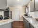 Efficient kitchen features stainless steel appliances, granite countertops, and a door to the backyard at 4453 S Pagosa Way, Aurora, CO 80015