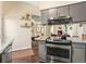 Open kitchen area with modern appliances, granite countertops, and seamless flow to the dining area at 4453 S Pagosa Way, Aurora, CO 80015