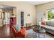 A cozy living room featuring warm wood flooring, comfortable furniture, and stylish decor at 4453 S Pagosa Way, Aurora, CO 80015
