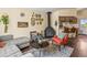 Inviting living area with a fireplace, stylish decor, and comfortable seating on a patterned rug at 4453 S Pagosa Way, Aurora, CO 80015
