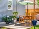 Back patio features a dining set under an umbrella, creating a perfect space for outdoor relaxation and entertainment at 4453 S Pagosa Way, Aurora, CO 80015