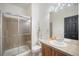 Well-lit bathroom features a tiled shower with sliding glass door, tiled countertop, and sink at 11712 Lewiston St, Commerce City, CO 80022