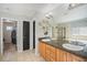 Well-lit bathroom boasts double sinks, granite counters, and tiled floors at 11712 Lewiston St, Commerce City, CO 80022