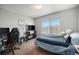 Carpeted bedroom includes an office area, built-in shelves, and a comfortable bed at 11712 Lewiston St, Commerce City, CO 80022