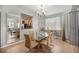 Elegant dining room featuring a glass table, hardwood floors, and natural lighting at 11712 Lewiston St, Commerce City, CO 80022