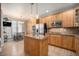 Modern kitchen featuring stainless steel appliances, wood cabinets, and a center island at 11712 Lewiston St, Commerce City, CO 80022