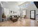 Bright living room with vaulted ceilings, large windows, and hardwood floors at 11712 Lewiston St, Commerce City, CO 80022