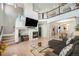 Bright living room featuring a fireplace, hardwood floors, and an open floor plan into the dining area at 11712 Lewiston St, Commerce City, CO 80022