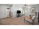 Spacious carpeted living room with ceiling fan and sitting area at 11712 Lewiston St, Commerce City, CO 80022