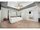 Carpeted primary bedroom features a ceiling fan, neutral paint, and indirect lighting at 11712 Lewiston St, Commerce City, CO 80022