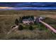 Expansive rural estate featuring a sprawling home with lush landscaping and a separate outbuilding at 3487 Willownook Ranch Trl, Elizabeth, CO 80107