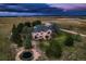 Aerial view of home with outbuilding, mature trees and trampoline at 3487 Willownook Ranch Trl, Elizabeth, CO 80107