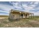Exterior view of a horse barn with stalls, featuring a gated entrance and pasture views at 3487 Willownook Ranch Trl, Elizabeth, CO 80107