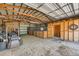 Open barn interior featuring stalls, storage, and riding lawn mower at 3487 Willownook Ranch Trl, Elizabeth, CO 80107