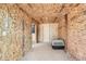 Barn interior with plywood walls and an animal crate next to a doorway to the stables at 3487 Willownook Ranch Trl, Elizabeth, CO 80107