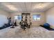 Carpeted basement gym with exercise equipment and natural light from two windows at 3487 Willownook Ranch Trl, Elizabeth, CO 80107