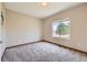 Neutral bedroom featuring wall-to-wall carpeting and a large window for natural light at 3487 Willownook Ranch Trl, Elizabeth, CO 80107