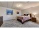 Carpeted bedroom with a rustic wood bed frame and a window with natural light at 3487 Willownook Ranch Trl, Elizabeth, CO 80107