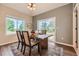 Inviting dining area with a rustic table, chairs, and sliding glass doors to the backyard at 3487 Willownook Ranch Trl, Elizabeth, CO 80107