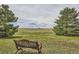 Scenic view from a metal bench, featuring a sprawling meadow and scattered trees at 3487 Willownook Ranch Trl, Elizabeth, CO 80107