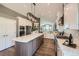 Spacious kitchen with white cabinets, stainless appliances, marble countertops, and a large island at 3487 Willownook Ranch Trl, Elizabeth, CO 80107