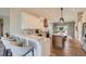 Bright kitchen with white cabinets, marble countertops, wood floors, and stainless steel appliances at 3487 Willownook Ranch Trl, Elizabeth, CO 80107