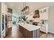 Bright, open-concept kitchen with white cabinetry, granite counters, and modern appliances at 3487 Willownook Ranch Trl, Elizabeth, CO 80107