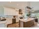 Well-lit kitchen with custom cabinets, center island, stainless steel appliances, and wood flooring at 3487 Willownook Ranch Trl, Elizabeth, CO 80107
