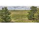View of beautiful acreage with scattered homes in the distance and dramatic clouds above at 3487 Willownook Ranch Trl, Elizabeth, CO 80107