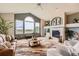 Comfortable living room featuring many windows, vaulted ceiling, fireplace and neutral décor at 3487 Willownook Ranch Trl, Elizabeth, CO 80107