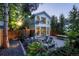 Beautifully landscaped backyard featuring multiple outdoor seating areas, and mature trees at 4508 Lowell Blvd, Denver, CO 80211