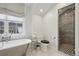 Bathroom featuring soaking tub, natural light and tiled shower at 4508 Lowell Blvd, Denver, CO 80211