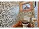 Stylish bathroom featuring custom wallpaper, decorative wood trim and a wood-seat toilet at 4508 Lowell Blvd, Denver, CO 80211