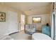 Bright bedroom featuring a crib, built-in shelving, and a modern TV at 4508 Lowell Blvd, Denver, CO 80211