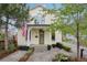 Beautiful home featuring a quaint covered porch, green door, and manicured landscaping with an American flag at 4508 Lowell Blvd, Denver, CO 80211